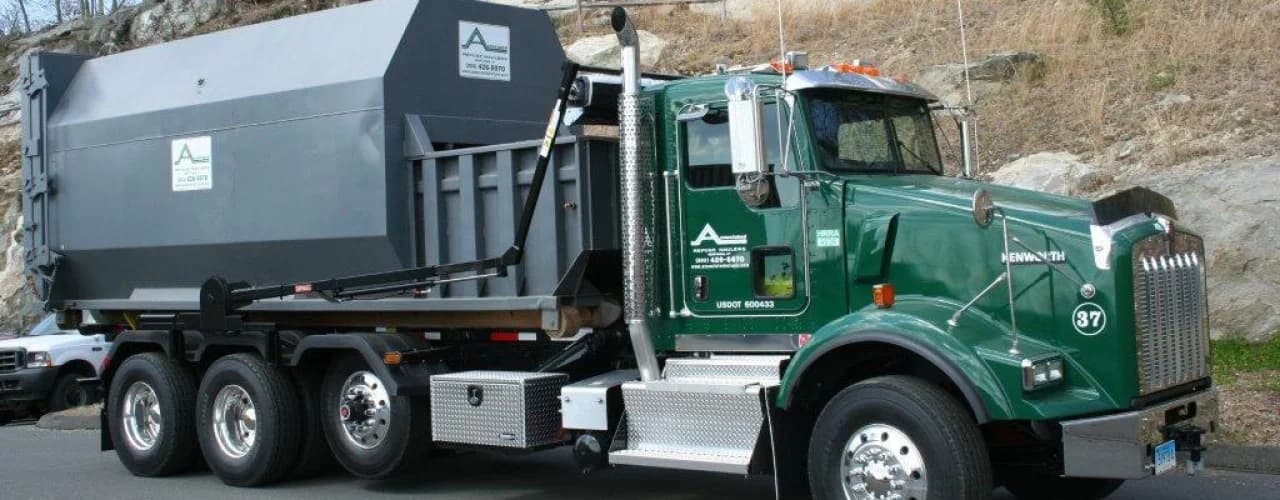 Associated Refuse Haulers roll-off truck delivering a container in Fairfield County, CT